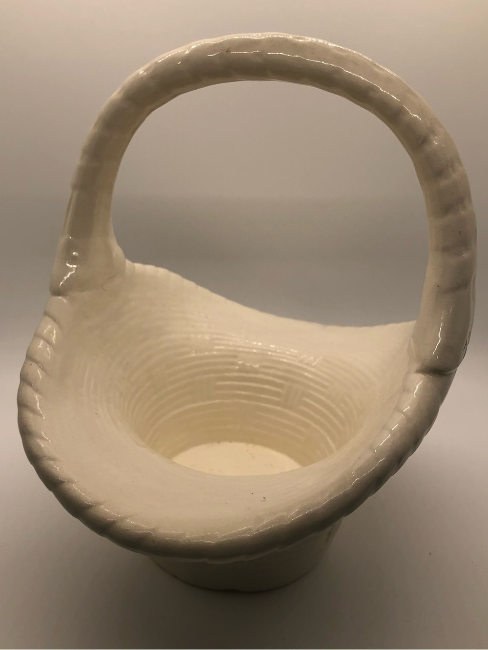 Vintage Ceramic basket features a textured weave design and a sculpted handle
